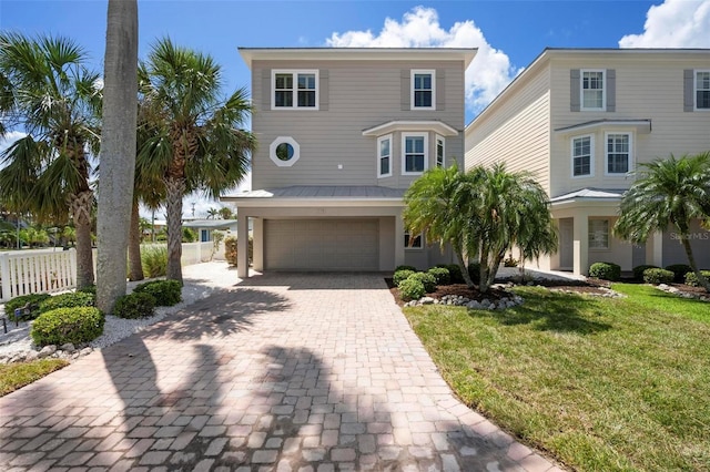 view of front of home featuring driveway, a garage, and stucco siding