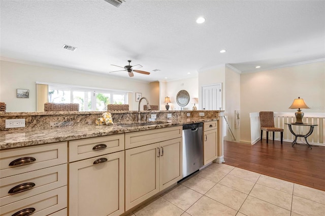 kitchen featuring dishwasher, a sink, ceiling fan, crown molding, and light tile patterned floors