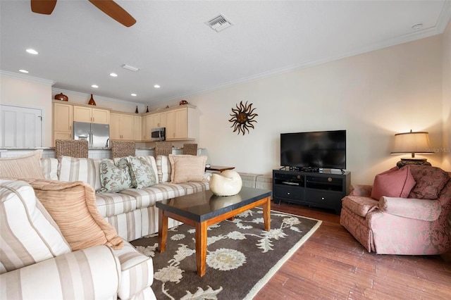 living room with crown molding, wood finished floors, ceiling fan, and recessed lighting