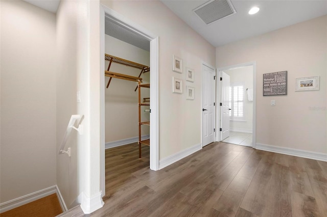 hallway with baseboards and wood finished floors