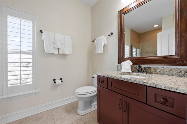 bathroom featuring baseboards, toilet, tile patterned flooring, and vanity