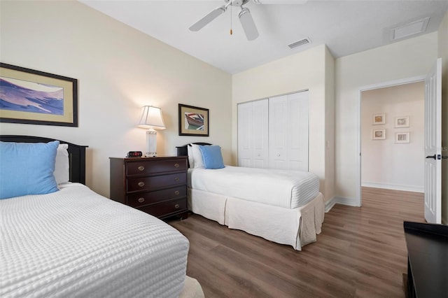 bedroom with wood finished floors, a closet, baseboards, and a ceiling fan