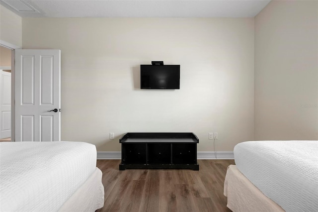 bedroom featuring wood finished floors and baseboards