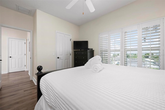 bedroom featuring wood finished floors, baseboards, and ceiling fan