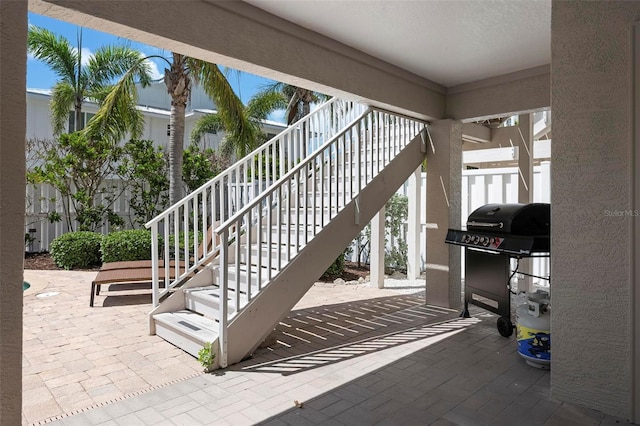 view of patio / terrace featuring stairs and grilling area