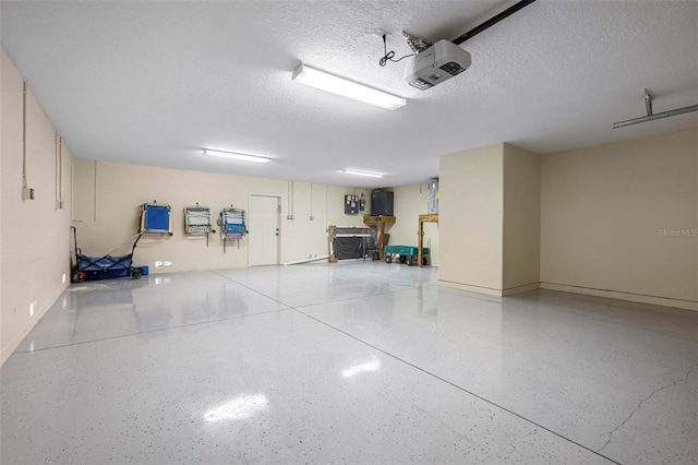 garage with a garage door opener and baseboards