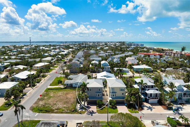 aerial perspective of suburban area with a nearby body of water
