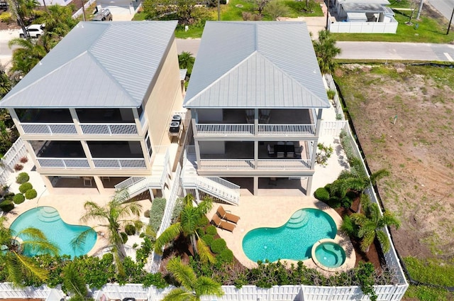 aerial view of property and surrounding area with a pool area