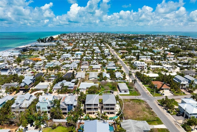 aerial view of residential area featuring a large body of water