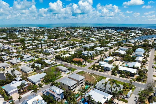 aerial view of residential area featuring a large body of water