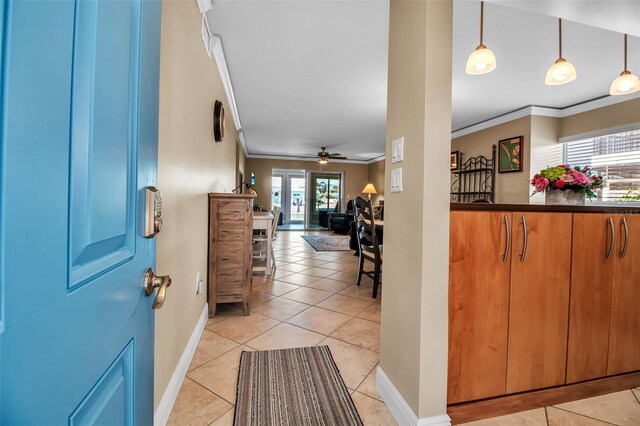 10423 Waterbird Way Unit 10423, Bradenton, FL 34209 - foyer with a ceiling fan, crown molding, light tile patterned floors, and baseboards