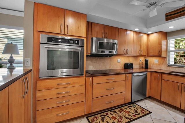 10423 Waterbird Way Unit 10423, Bradenton, FL 34209 - kitchen featuring stainless steel appliances, decorative backsplash, dark countertops, ceiling fan, and recessed lighting