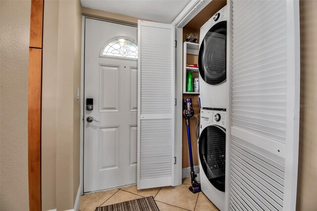 10423 Waterbird Way Unit 10423, Bradenton, FL 34209 - washroom featuring stacked washer / dryer and light tile patterned floors