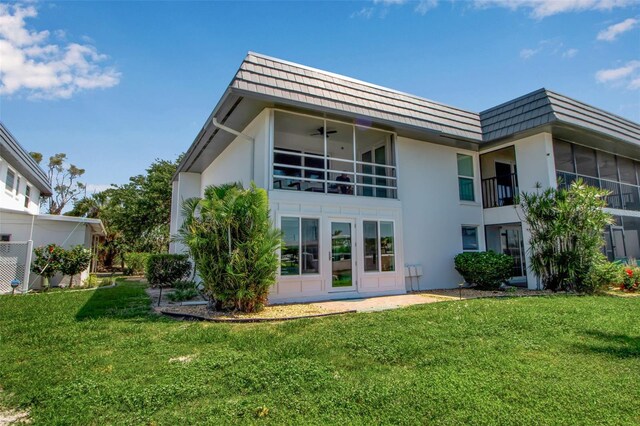 10423 Waterbird Way Unit 10423, Bradenton, FL 34209 - back of house featuring mansard roof, stucco siding, a yard, and ceiling fan