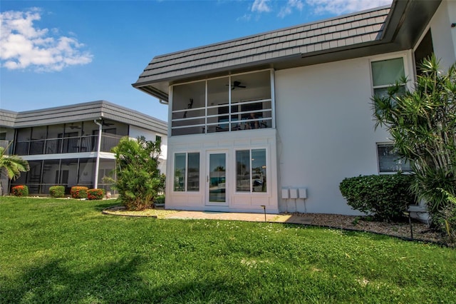 10423 Waterbird Way Unit 10423, Bradenton, FL 34209 - rear view of property featuring stucco siding, a yard, and mansard roof