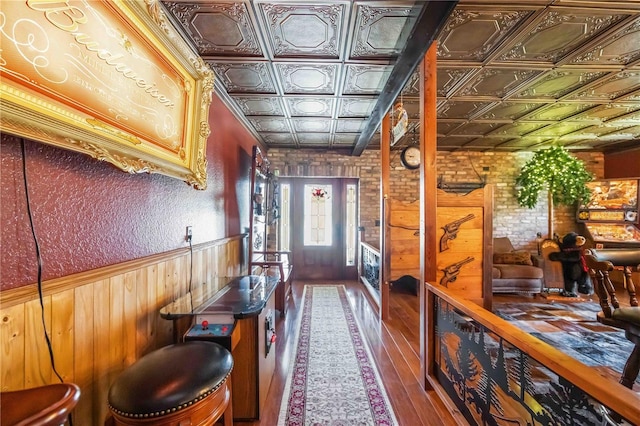 4225 Ulman Ave, North Port, FL 34286 - doorway with an ornate ceiling, wood walls, hardwood / wood-style flooring, and wainscoting