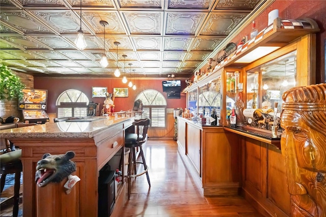 4225 Ulman Ave, North Port, FL 34286 - bar featuring an ornate ceiling, light wood finished floors, and a wainscoted wall