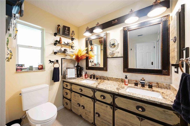 4225 Ulman Ave, North Port, FL 34286 - bathroom featuring toilet, double vanity, and tile patterned flooring