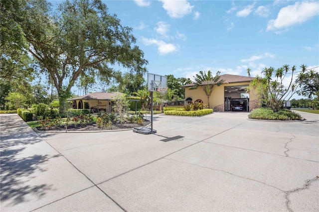 4225 Ulman Ave, North Port, FL 34286 - view of front of property featuring curved driveway, stucco siding, and a gate