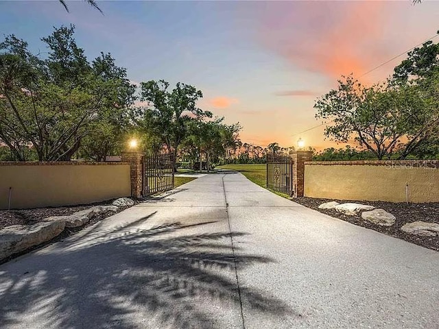 4225 Ulman Ave, North Port, FL 34286 - view of concrete surface featuring a gate and a gated entry
