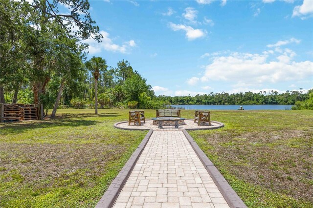 4225 Ulman Ave, North Port, FL 34286 - view of green lawn featuring an outdoor fire pit and a water view