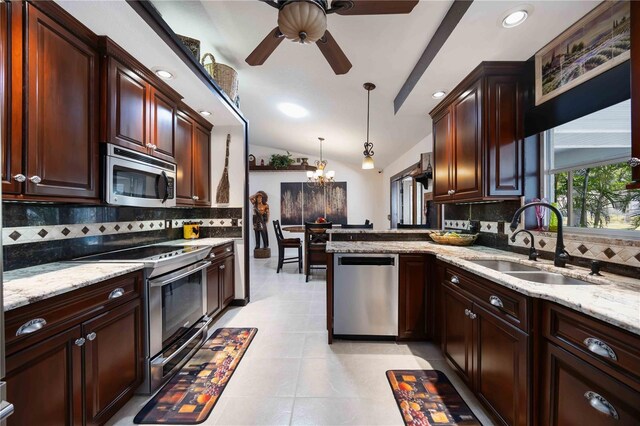 4225 Ulman Ave, North Port, FL 34286 - kitchen featuring appliances with stainless steel finishes, a sink, a chandelier, backsplash, and a ceiling fan