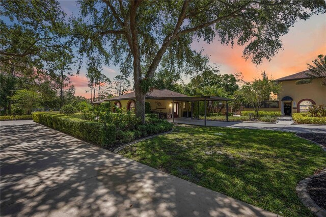 4225 Ulman Ave, North Port, FL 34286 - view of front of home featuring a yard and stucco siding