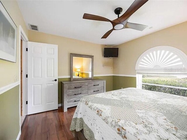 4225 Ulman Ave, North Port, FL 34286 - bedroom featuring dark wood-style flooring, a ceiling fan, and baseboards