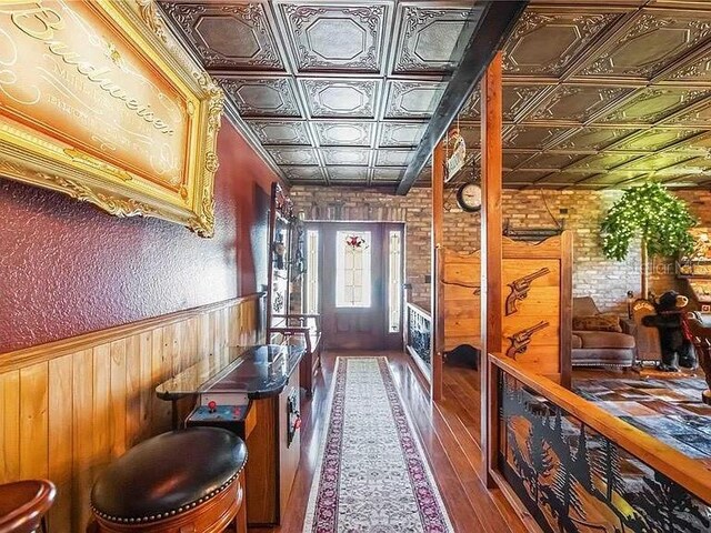 4225 Ulman Ave, North Port, FL 34286 - foyer featuring an ornate ceiling, wooden walls, wood finished floors, and wainscoting