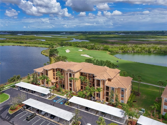drone / aerial view of a large body of water and a golf course