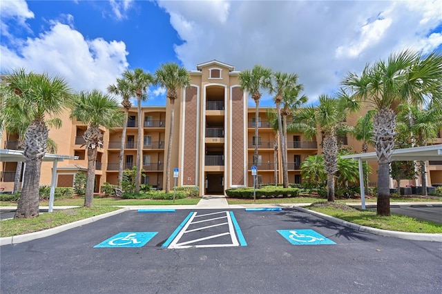 view of apartment building / complex with uncovered parking