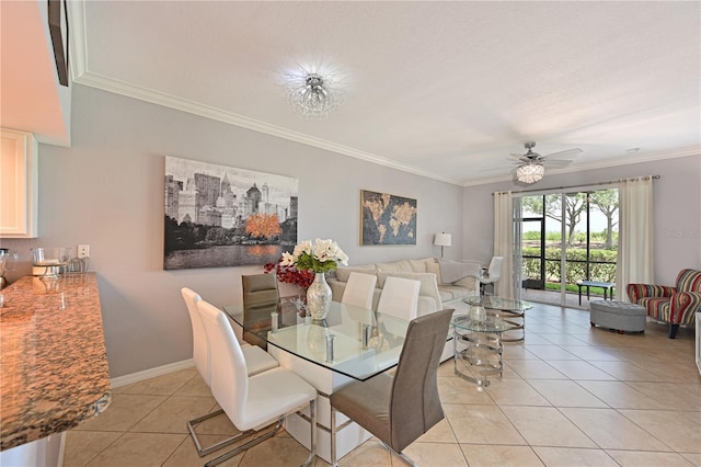 dining room featuring light tile patterned flooring, ornamental molding, ceiling fan, and baseboards