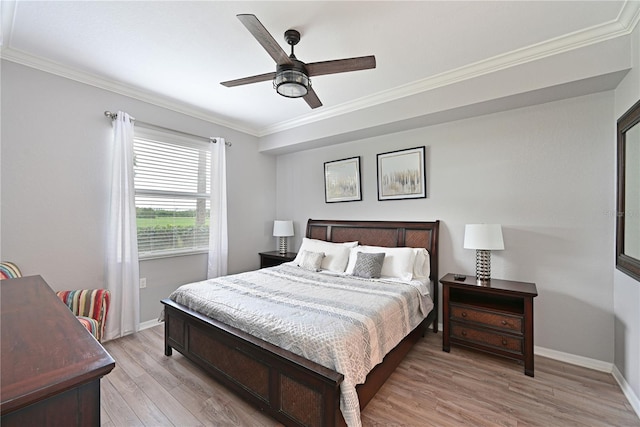 bedroom with crown molding, light wood-style floors, baseboards, and ceiling fan