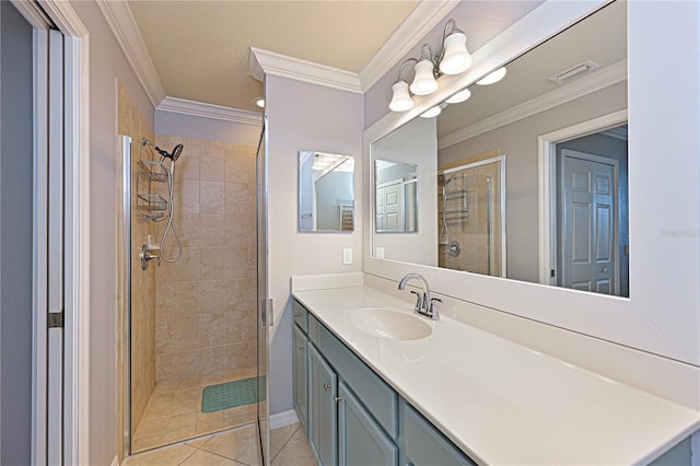 bathroom with a shower stall, ornamental molding, tile patterned floors, and vanity