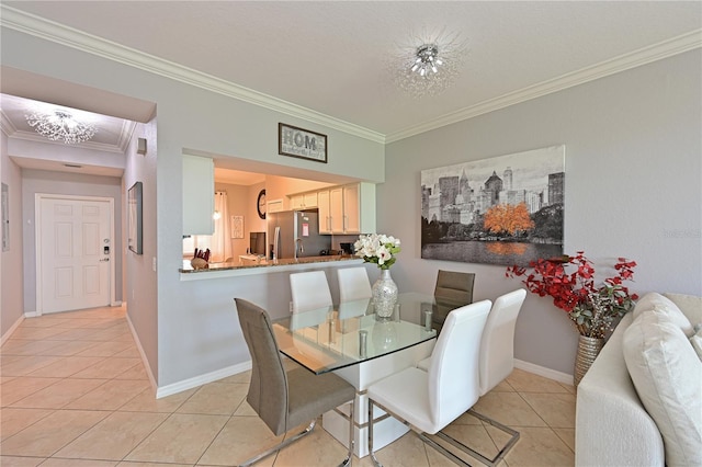 dining space featuring ornamental molding, light tile patterned flooring, and baseboards
