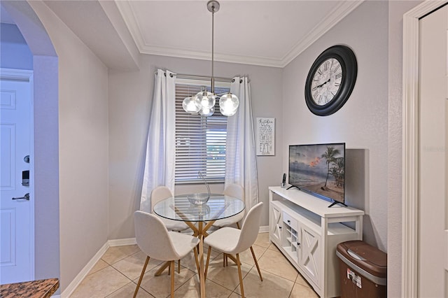 dining room with a chandelier, arched walkways, light tile patterned flooring, ornamental molding, and baseboards