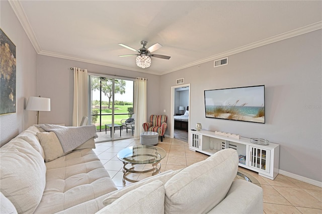 living area with light tile patterned floors, ceiling fan, crown molding, and baseboards