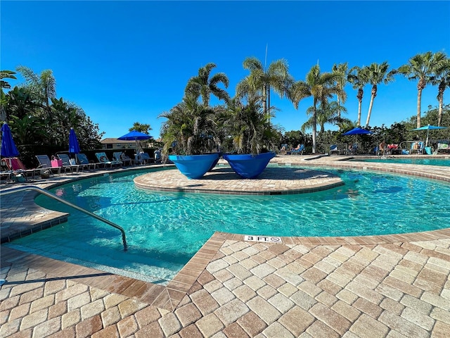 community pool with a patio area