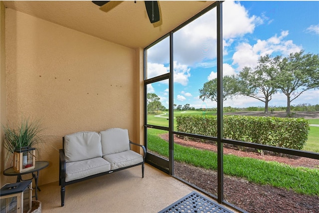 sunroom with ceiling fan, lofted ceiling, and golf course view