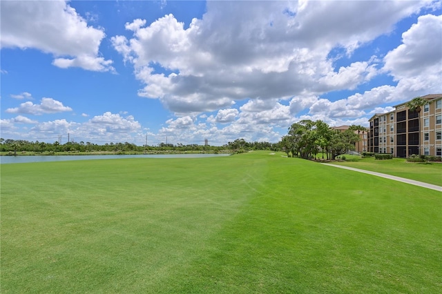 view of home's community with a water view and golf course view
