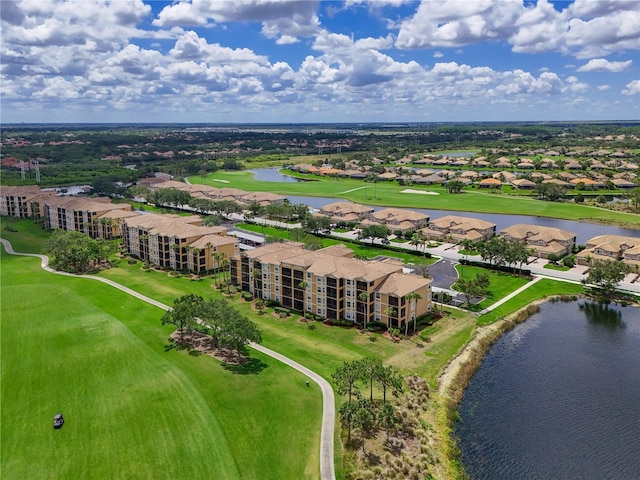 bird's eye view of a large body of water, a golf course, and apartment complex