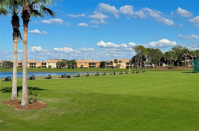 view of community featuring a yard, a water view, and a residential view