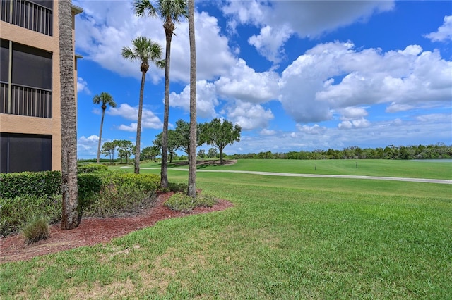view of green lawn with golf course view