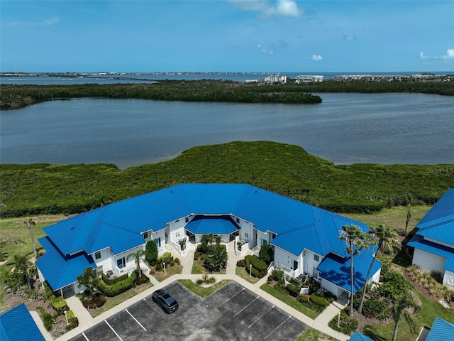 aerial view of property and surrounding area with a large body of water
