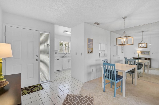 dining space featuring light tile patterned flooring, a textured ceiling, and a chandelier