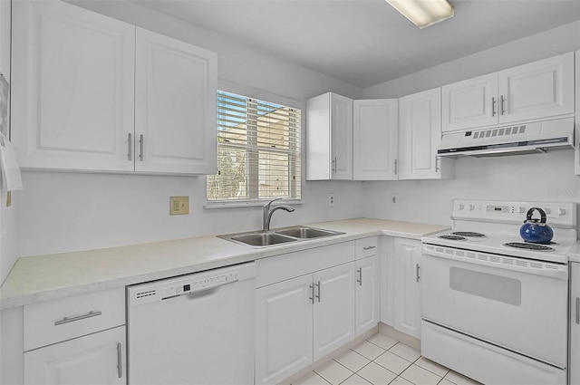 kitchen with white appliances, under cabinet range hood, a sink, and white cabinetry