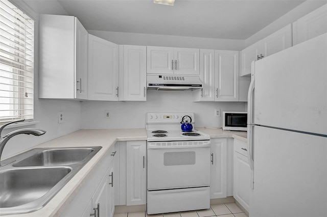 kitchen featuring white appliances, under cabinet range hood, a sink, and white cabinetry
