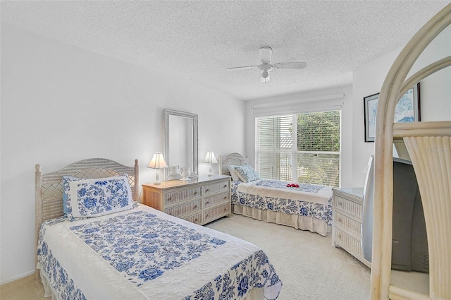 bedroom with carpet flooring, a textured ceiling, and a ceiling fan