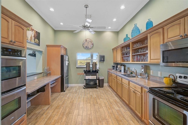 kitchen featuring stainless steel appliances, a sink, ceiling fan, open shelves, and baseboards
