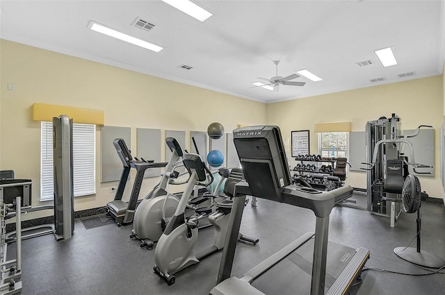 gym with ceiling fan and ornamental molding